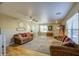 Bright living room featuring wood floors, ceiling fan, and comfortable seating arrangement at 3790 W White Canyon Rd, San Tan Valley, AZ 85144