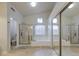 Bright bathroom offers a soaking tub, glass shower, and a neutral tile floor at 3834 E Windsong Dr, Phoenix, AZ 85048