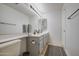Bathroom featuring double sinks with gray cabinets, an oversized mirror, and modern fixtures at 3834 E Windsong Dr, Phoenix, AZ 85048