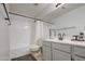 Bathroom featuring a shower-tub combo and grey vanity with updated fixtures at 3834 E Windsong Dr, Phoenix, AZ 85048