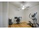 Versatile room features a ceiling fan, wood-look flooring, and gym equipment at 3834 E Windsong Dr, Phoenix, AZ 85048
