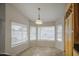 Cozy dining area with pendant lighting and a bright window bay with views of the yard at 3834 E Windsong Dr, Phoenix, AZ 85048