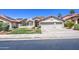 Charming single-story home with a three-car garage, desert landscaping, and solar panels at 3834 E Windsong Dr, Phoenix, AZ 85048