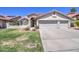 Charming single-story home with a well-maintained front yard and three-car garage, perfect for a Gathering at 3834 E Windsong Dr, Phoenix, AZ 85048