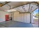 Spacious garage with built-in storage cabinets, a red tool chest, and a pull-up garage door at 3834 E Windsong Dr, Phoenix, AZ 85048