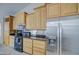Bright kitchen featuring stainless steel appliances, wooden cabinets, and tile flooring at 3834 E Windsong Dr, Phoenix, AZ 85048