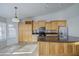 Bright kitchen with light cabinets, dark countertops, island with sink, and modern appliances invites culinary creativity at 3834 E Windsong Dr, Phoenix, AZ 85048