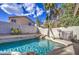 Sparkling pool with rock waterfall feature, surrounded by lush landscaping at 3834 E Windsong Dr, Phoenix, AZ 85048