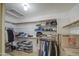 Spacious walk-in closet with custom shelving, hanging racks, and ample storage space at 3834 E Windsong Dr, Phoenix, AZ 85048