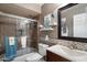 Bathroom featuring a single sink vanity, a large mirror, and a shower-tub combo at 3926 W Christy Dr, Phoenix, AZ 85029
