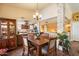 Dining room features a wooden table and seating, plus a view of the kitchen and accent stone walls at 3926 W Christy Dr, Phoenix, AZ 85029