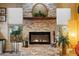 Stone fireplace with mantle decor, candles, indoor plants, and electric fireplace at 3926 W Christy Dr, Phoenix, AZ 85029
