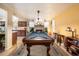 Recreation area with a pool table and fireplace that opens to the kitchen at 3926 W Christy Dr, Phoenix, AZ 85029