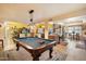 Recreation area with a pool table, opening to the kitchen and living room at 3926 W Christy Dr, Phoenix, AZ 85029