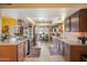 Spacious kitchen featuring dark wood cabinetry, granite counters, and stainless steel appliances at 3926 W Christy Dr, Phoenix, AZ 85029