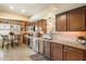 Bright kitchen with dark wood cabinets, updated appliances, and a cozy dining area at 3926 W Christy Dr, Phoenix, AZ 85029