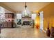 A bright room with a stone fireplace, tile flooring, warm lighting, and views of the surrounding greenery at 3926 W Christy Dr, Phoenix, AZ 85029
