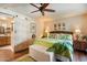 Comfortable main bedroom featuring wood-look floors and a barn door leading to ensuite bathroom at 3926 W Christy Dr, Phoenix, AZ 85029