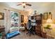 Home office with built-in desk and shelves, a comfortable chair, and a large window at 3926 W Christy Dr, Phoenix, AZ 85029
