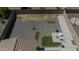 Aerial view shows a gravel backyard with a patio and some artificial turf at 40893 W Bedford Dr, Maricopa, AZ 85138
