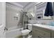 Charming bathroom with subway tile, striped walls, framed mirror and modern vanity at 40893 W Bedford Dr, Maricopa, AZ 85138