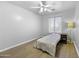 Relaxing bedroom with ceiling fan, window for natural light and wood-look floors at 40893 W Bedford Dr, Maricopa, AZ 85138