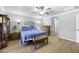 Bright bedroom with ceiling fan and furniture against a brick accent wall at 40893 W Bedford Dr, Maricopa, AZ 85138