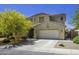 Charming two-story stucco home with a spacious two-car garage and well-maintained landscaping at 40893 W Bedford Dr, Maricopa, AZ 85138