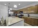 Well-lit kitchen boasts stainless appliances, granite countertops, and center island with a sink at 40893 W Bedford Dr, Maricopa, AZ 85138