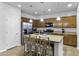 Modern kitchen featuring stainless steel appliances, a large island with barstool seating, and ample cabinetry at 40893 W Bedford Dr, Maricopa, AZ 85138
