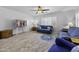 Inviting living room features hardwood floors, comfortable seating, and a large window for natural light at 40893 W Bedford Dr, Maricopa, AZ 85138
