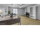 Spacious office with custom desks, bookshelves, and ceiling fan for working from home at 40893 W Bedford Dr, Maricopa, AZ 85138