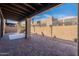 Spacious covered back patio with a custom brick floor and desert landscaping, perfect for relaxing outdoors at 4116 E Sunnyside Dr, Phoenix, AZ 85028