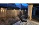 Backyard features a decorative privacy fence, desert landscaping, outdoor lighting and lounge chairs on decorative patio at 4116 E Sunnyside Dr, Phoenix, AZ 85028