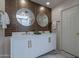 Elegant bathroom with a double sink vanity and stylish round mirrors at 4116 E Sunnyside Dr, Phoenix, AZ 85028