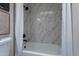 This remodeled bathroom has a shower and tub combination with stylish tile at 4116 E Sunnyside Dr, Phoenix, AZ 85028
