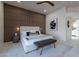 Modern bedroom featuring wood-slat accent wall, neutral color palette, and shuttered windows at 4116 E Sunnyside Dr, Phoenix, AZ 85028
