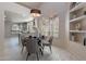 Dining area with round table, modern chandelier, window shutters, and seamlessly connected open floor plan at 4116 E Sunnyside Dr, Phoenix, AZ 85028