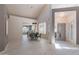 Well-lit dining area with modern table set, elegant light fixture, and open view to the kitchen at 4116 E Sunnyside Dr, Phoenix, AZ 85028