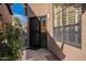 Private front entryway with black security screen door and well maintained yard at 4116 E Sunnyside Dr, Phoenix, AZ 85028