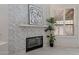 Close up of modern fireplace with decorative stone detail, shutters, and clean, contemporary design at 4116 E Sunnyside Dr, Phoenix, AZ 85028
