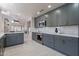Modern kitchen features stylish gray cabinets, stainless steel appliances, and white countertops at 4116 E Sunnyside Dr, Phoenix, AZ 85028