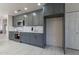 Modern kitchen features stylish gray cabinets, stainless steel appliances, and white countertops at 4116 E Sunnyside Dr, Phoenix, AZ 85028