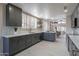 Modern kitchen features stylish gray cabinets, stainless steel appliances, and white countertops at 4116 E Sunnyside Dr, Phoenix, AZ 85028