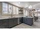 Modern kitchen features stylish gray cabinets, stainless steel appliances, and white countertops at 4116 E Sunnyside Dr, Phoenix, AZ 85028