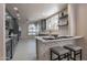 Bright modern kitchen with bar seating, stainless appliances, and gray cabinets at 4116 E Sunnyside Dr, Phoenix, AZ 85028