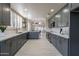 Modern kitchen features stylish gray cabinets, stainless steel appliances, and white countertops at 4116 E Sunnyside Dr, Phoenix, AZ 85028