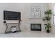 Bright living area featuring a modern fireplace, stylish decor, and sleek entertainment console at 4116 E Sunnyside Dr, Phoenix, AZ 85028