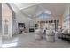 Bright living room with vaulted ceilings, fireplace, shutters, and modern decor creates a welcoming space at 4116 E Sunnyside Dr, Phoenix, AZ 85028