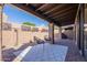 The home's covered patio has a relaxing seating area and low maintenance landscaping at 4116 E Sunnyside Dr, Phoenix, AZ 85028